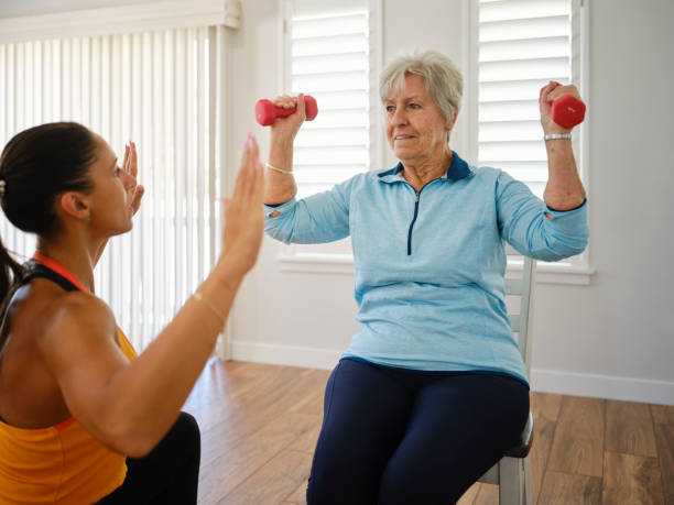 istock Physical Trainer Working with a Senior Aged Woman in a Home 2167965112