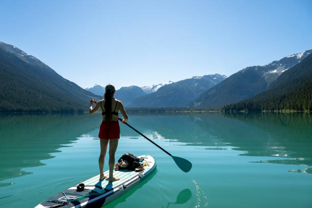 istock Woman SUP boards across mountain lake 2167965500