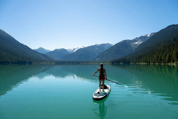 istock Woman SUP boards across mountain lake 2167965501