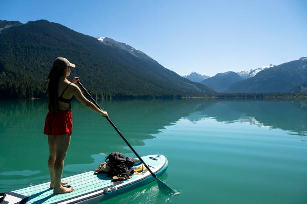 istock Woman SUP boards across mountain lake 2167965517