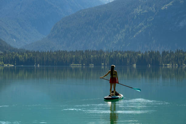 istock Woman SUP boards across mountain lake 2167965581
