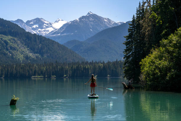 istock Woman SUP boards across mountain lake 2167965619