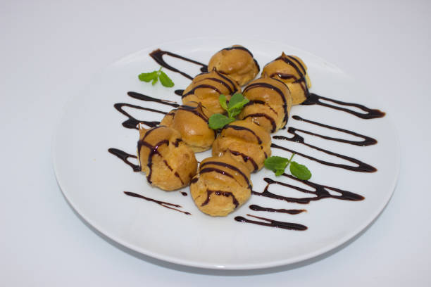 istock Profiteroles Drizzled with Chocolate Sauce 2167967760