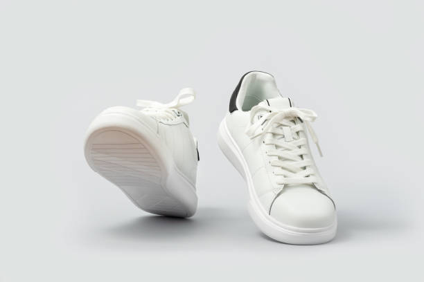 istock White leather sneakers on gray background 2167967993