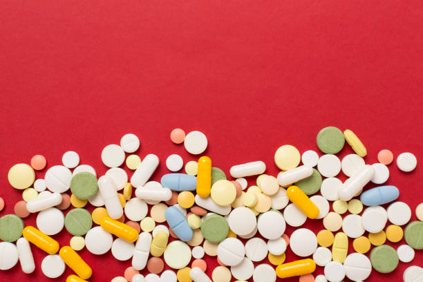istock Different medical pills and capsules on color background, top view 2167969712