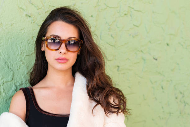 Beautiful young woman outdoor fashion portrait wearing sunglasses