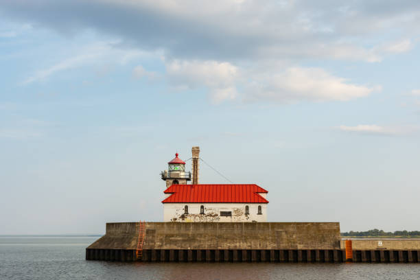 Duluth North Pier Lighthouse with blue skies in the afternoon light.