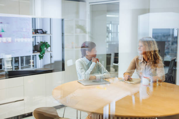 istock Colleagues sitting in the office and talking 2167980392