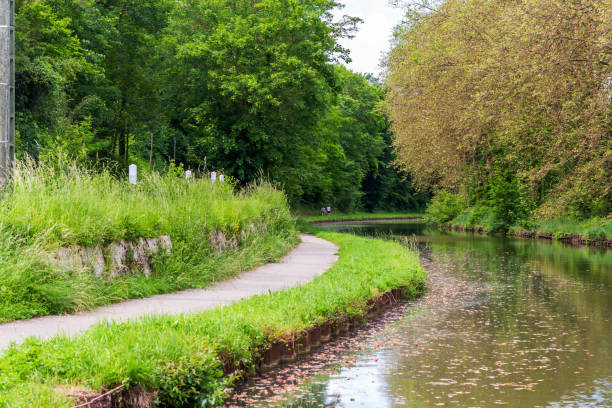 istock A scenic curved pathway along the Canal du Loing, surrounded by lush greenery and tranquil waters, offering a peaceful and picturesque setting 2167983177