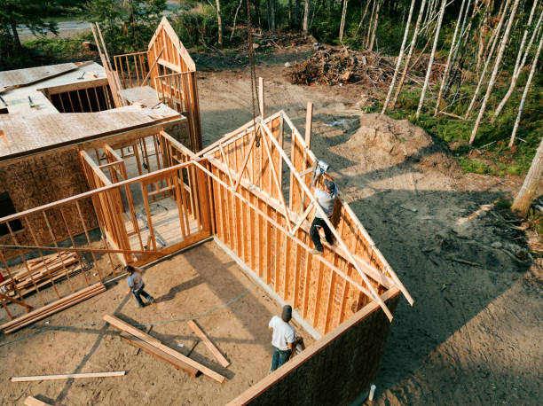 Construction Crew Putting Up Framing of New Home