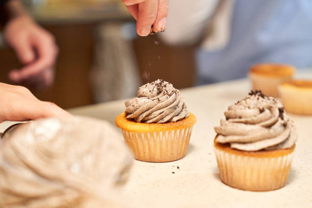 istock Crop woman decorating cupcakes with chocolate 2167989525