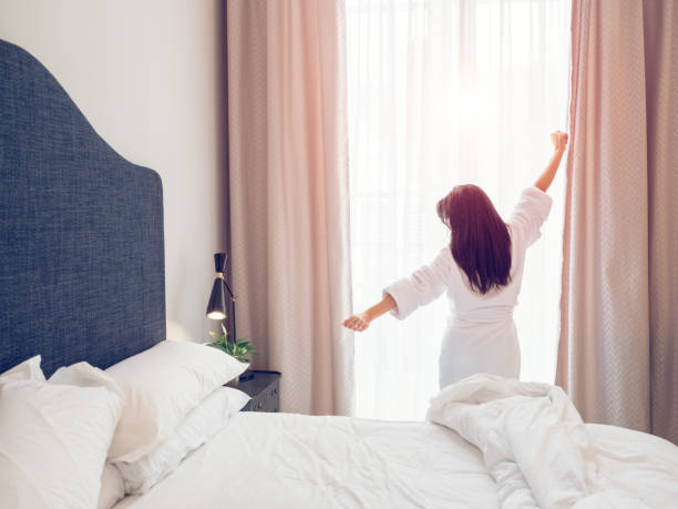 istock Anonymous woman waking up in bedroom 2167992083