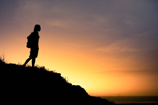 istock Men hiker looking at beautiful sunset view surroundings. 2167992089