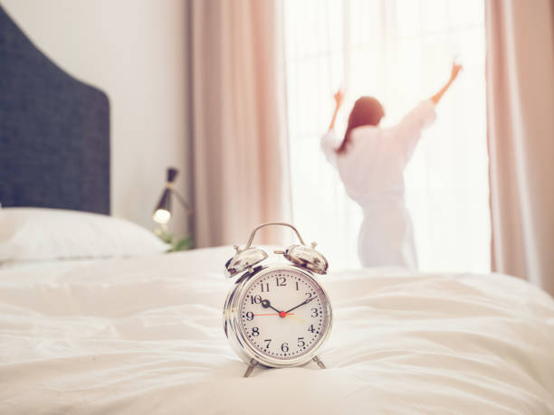 istock Anonymous woman waking up late in hotel 2167992103
