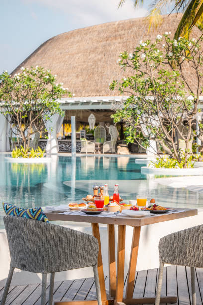 istock Maldives breakfast table by the pool under palm trees with scenic views on idyllic vacation island luxury resort 2167995502