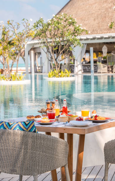 istock Maldives breakfast table by the pool under palm trees with scenic views on idyllic vacation island luxury resort 2167995562