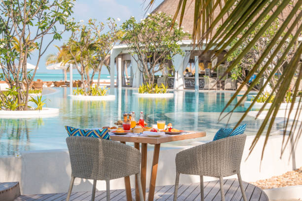 istock Maldives breakfast table by the pool under palm trees with scenic views on idyllic vacation island luxury resort 2167995581