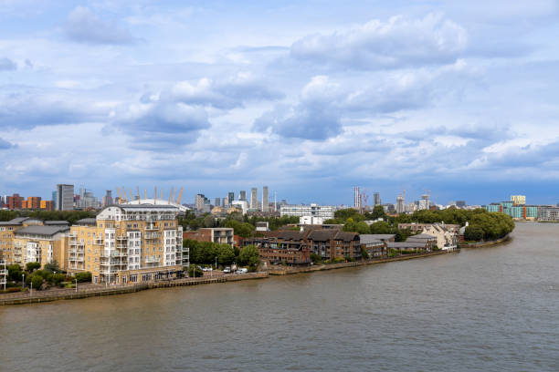 This image shows a daytime cityscape view of London, England, from the Thames River.