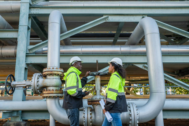 istock Engineer holding blueprint drawing to checking  gas pipeline. 2167999338
