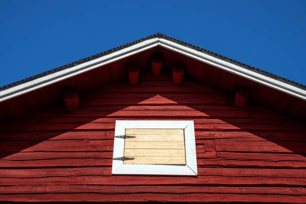 istock red painted log hut with closed hatch against blue sky 2167999945