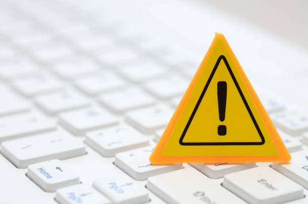istock The image of a yellow warning sign on a computer keyboard serves as a visual cue, alerting users to potential cybersecurity threats 2168003658