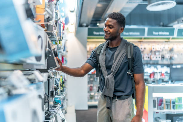 istock African man checking headphones in electronics store 2168005028
