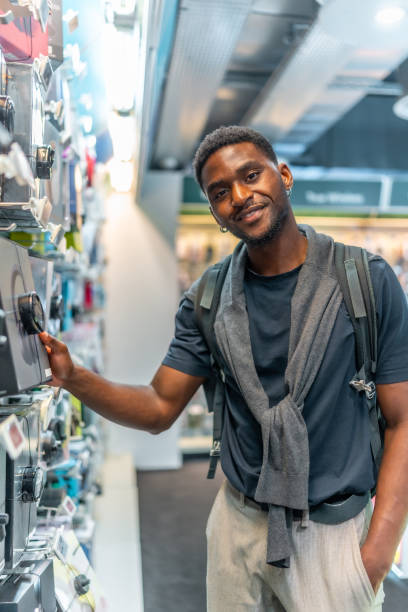 istock African young man in an electronics store 2168005029