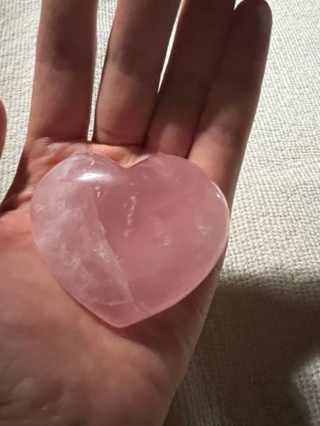 istock Rose quartz in the hand 2168005969