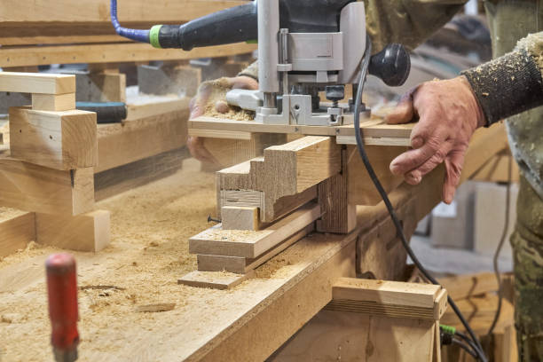 istock Carpenter milling wooden handrail with manual milling machine 2168008391