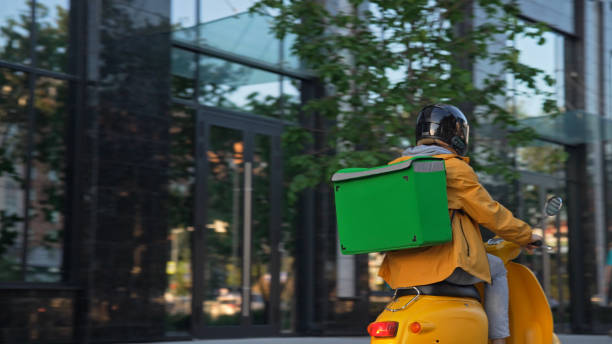 istock Express delivery service. Courier deliver products on yellow scooter backpack. 2168009410