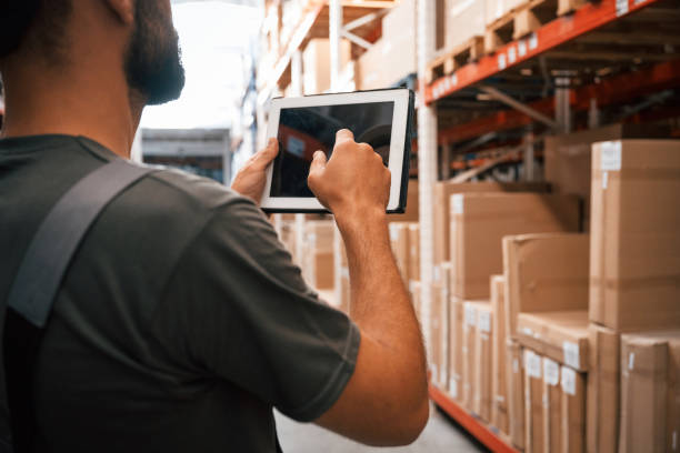istock Using the digital tablet. Foreman is in the storehouse, shipping distribution business 2168011147