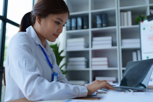 istock woman meticulously plans a finance audit, using a computer and calculator to review budget documents and ensure accuracy 2168012453