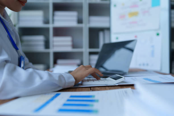 istock woman meticulously plans a finance audit, using a computer and calculator to review budget documents and ensure accuracy 2168012473