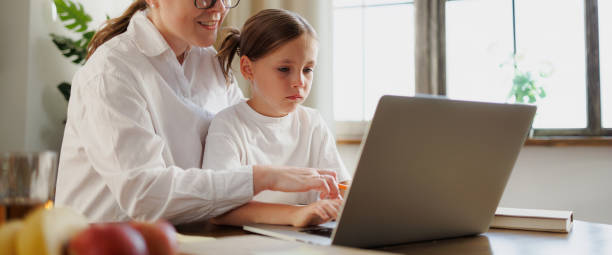istock Mother and child using laptop during online education at home, web banner 2168013245