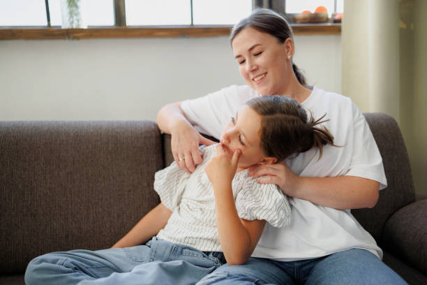 istock Smiling mother and child spending time on couch at home 2168013528