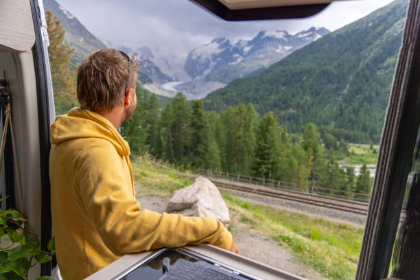 istock Man Relaxing in Camper Van with Mountain View 2168014377