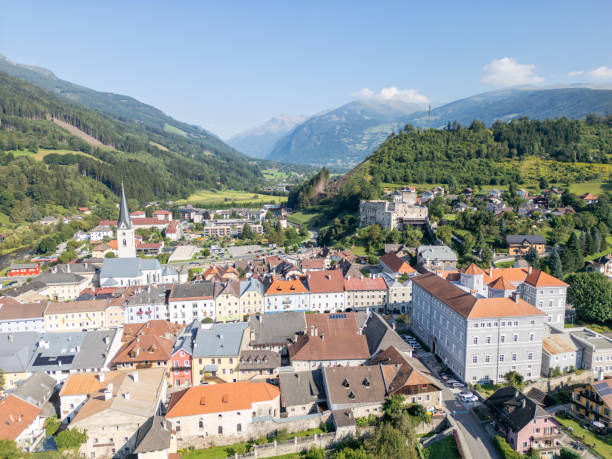 istock Charming Alpine Town Surrounded by Lush Hills and Mountains 2168014580