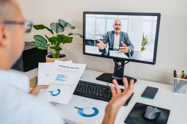 istock Mid-Adult Man Having A Work Video Call On A Computer At The Office 2168015442