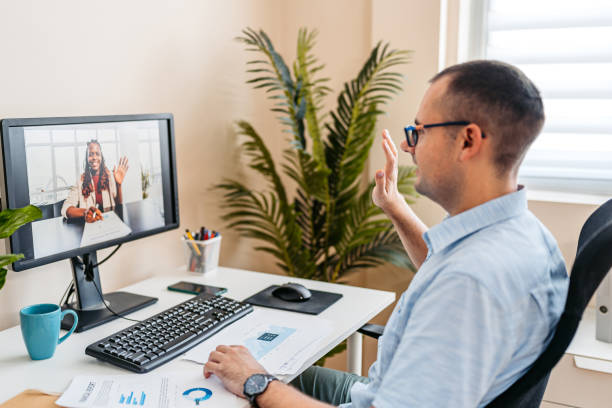 istock Mid-Adult Man Having A Work Video Call On A Computer At The Office 2168015815