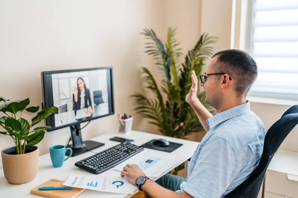 istock Mid-Adult Man Having A Work Video Call On A Computer At The Office 2168016021