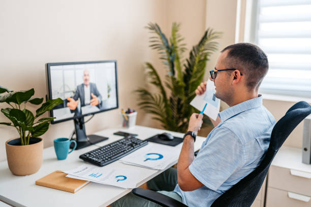 istock Mid-Adult Man Having A Work Video Call On A Computer At The Office 2168016053