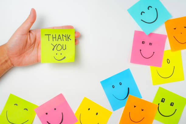 istock Thank you and smile icon inspirational handwriting on sticky notes on hand held 2168016065