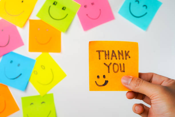 istock Thank you and smile icon inspirational handwriting on sticky notes on hand held 2168016099