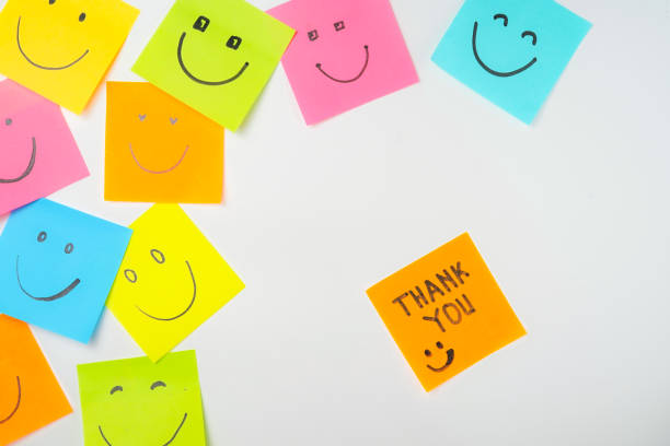 istock Thank you and smile icon inspirational handwriting on sticky notes on hand held 2168016122