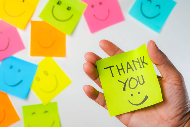 istock Thank you and smile icon inspirational handwriting on sticky notes on hand held 2168016123