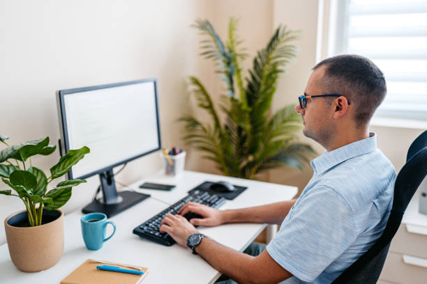 istock Mid-Adult Man Working On A Computer At The Office 2168016301