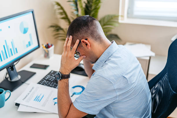 istock Tired Mid-Adult Man Working On A Computer At The Office 2168016624