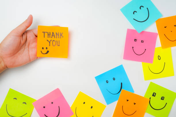 istock Thank you and smile icon inspirational handwriting on sticky notes on hand held 2168016641