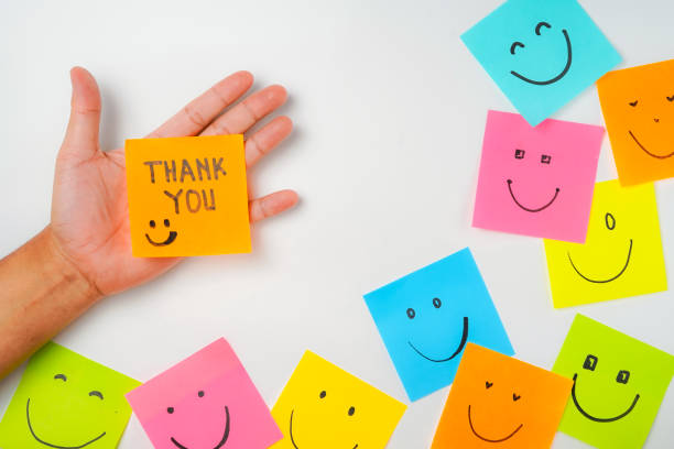istock Thank you and smile icon inspirational handwriting on sticky notes on hand held 2168016643