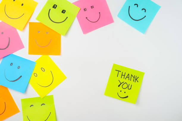 istock Thank you and smile icon inspirational handwriting on sticky notes on hand held 2168016669